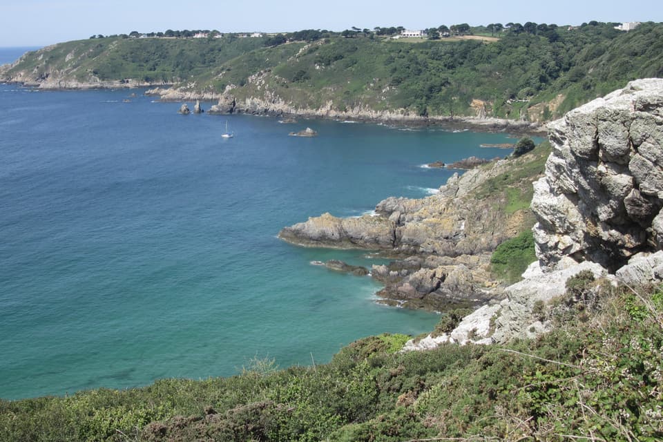 Guernsey's south coast cliffs at Moulin Huet Bay and Icart Point, above turquoise water