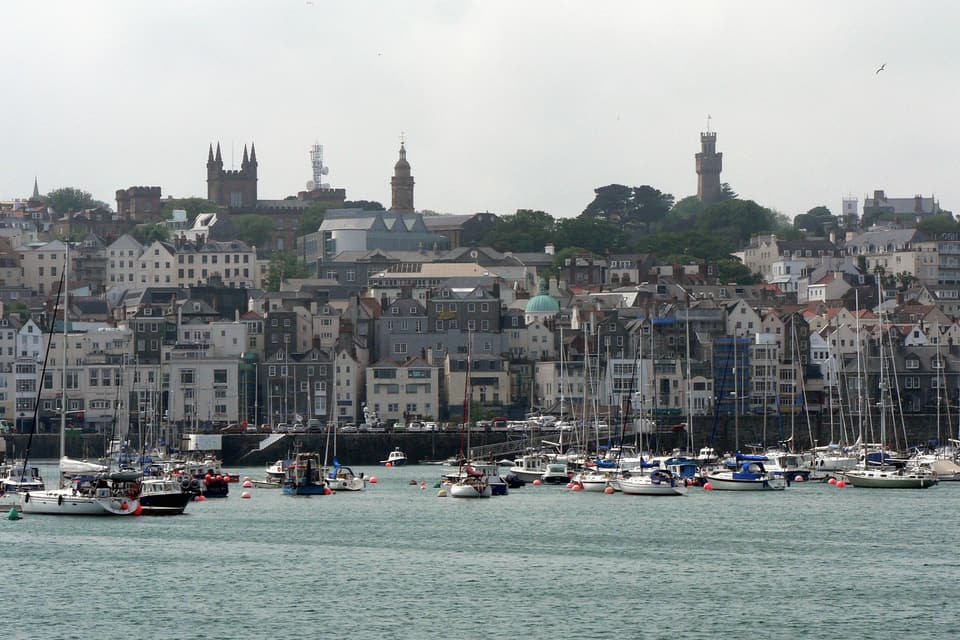 St Peter Port from the water, the Town Church and Victoria Tower above the marina