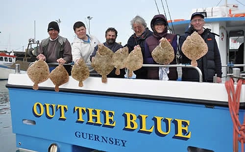 Six anglers hold turbot and brill over the sign-written stern